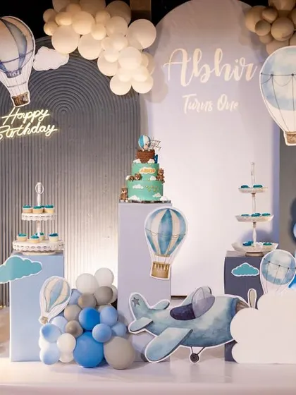 Another angle of the hot air balloon setup, showing the custom cake stands and dessert display.