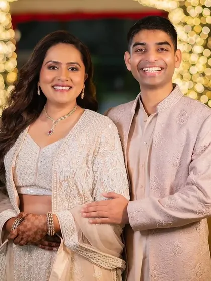 The happy couple. Her sangeet look is elegant and understated, with her hair down in soft waves and a natural makeup look.