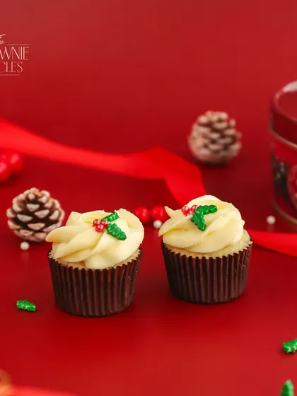 Our Carrot Cupcake is a festive favourite. It's moist, spiced, and topped with a classic cream cheese frosting and adorable holly sprinkles for the holiday season.