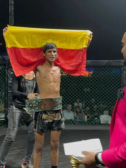 Holding the Karnataka flag and the championship belt high. This is the ultimate goal for our fighters, representing our state and winning titles.