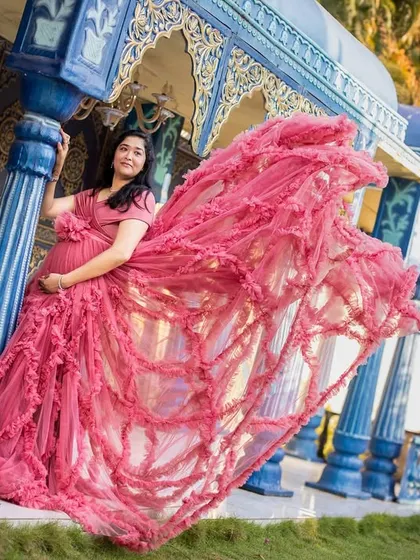 The movement of the pink gown adds life and energy to this shot, taken against a beautiful blue architectural set piece in our garden studio.