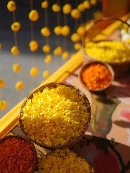 Bowls of fresh marigold petals ready for the Haldi ceremony, adding to the sensory experience of the event.