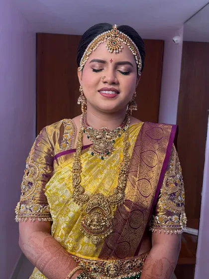 A beautiful, glossy look for a Bale Shastra (bangle ceremony). The eye makeup is soft and shimmery, and the skin is radiant, perfect for this happy occasion.