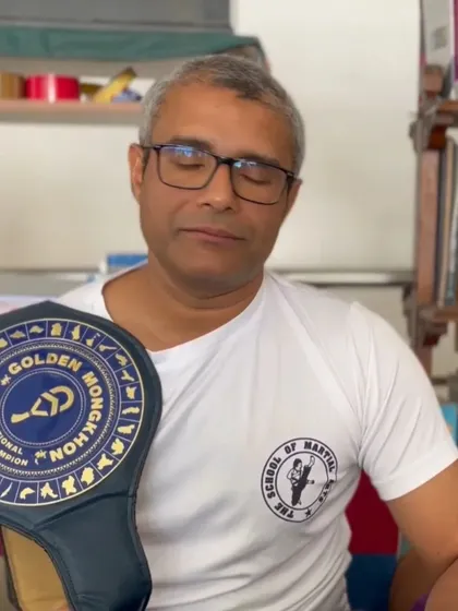 Master Ashwin Naidu with his hard-earned Golden Mongkhon championship belt. This victory is a result of decades of dedication to martial arts and serves as the ultimate proof of the effectiveness of our training.