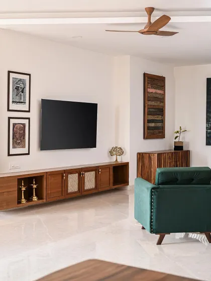 For this modern minimalist home, we designed a long, floating TV unit with integrated cane shutters. The clean lines and natural wood keep the space feeling open and uncluttered, allowing the family's art to stand out.
