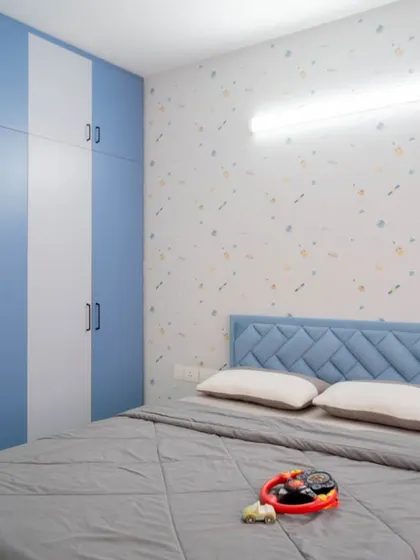 The wardrobe in the kid's room features a fun blue and white striped pattern, adding to the room's playful vibe.