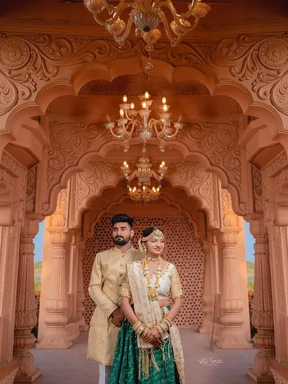 Another beautiful portrait framed by the palace arches. The lighting from the chandeliers adds a warm, romantic glow to this elegant couple shot.