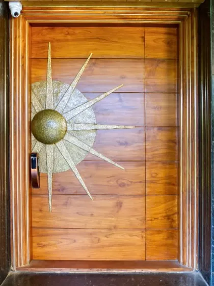 I believe in the power of craftsmanship. This oversized main door, made from FSC certified teak wood with a custom brass sun-themed handle, serves as a grand, artistic statement, setting a tone of bespoke quality from the very first touch.