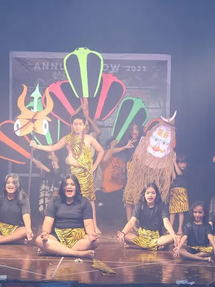 The performance incorporates creative props and masks to represent different aspects of the deity's story.