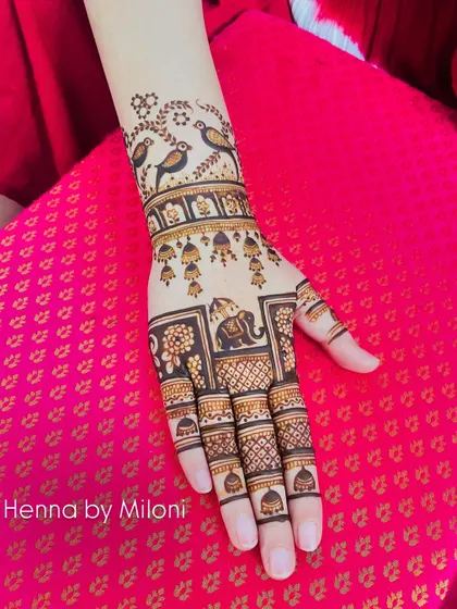 A traditional design with birds, bells, and an elephant. This design is full of classic motifs that tell a story.