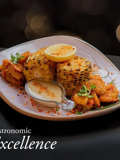 Gastronomic excellence on a plate. This dish features grilled corn on the cob paired with succulent prawns and a creamy sauce, demonstrating our flair for combining familiar ingredients in new ways.