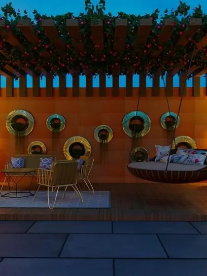 This twilight view captures the magical ambiance of a well-lit terrace. The design features a large pergola with climbing plants, a cozy hanging swing, and illuminated planters, creating an enchanting space for evening relaxation.