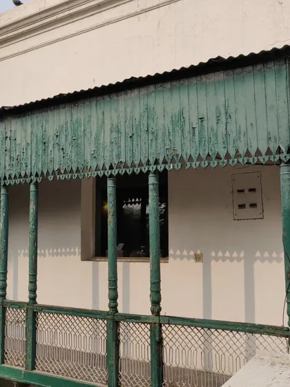 Another view of the dilapidated balcony before we began our work, highlighting the faded paint and weathered wood.