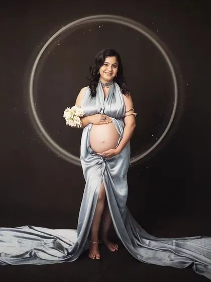 Explore our packages to get your maternity session done in stylish fabric drapes, like this beautiful silver-blue gown.