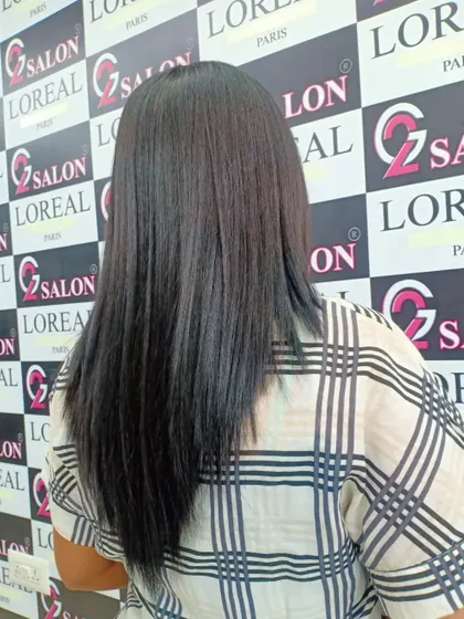 This client's hair is now sleek and straight with a healthy shine after her appointment. A simple U-cut adds shape to the final look.