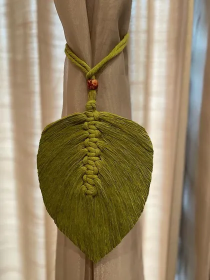 A practical and pretty way to hold back your curtains. This macrame curtain tie-back is designed in the shape of a leaf, blending function with natural beauty.