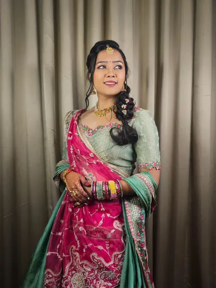 Another angle of the Mayra look, showing the elegant side-swept braid and the intricate details of her outfit.