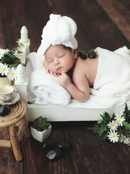 A different take on the baby spa day, with a hot stone massage on a tiny bed. It's all about creating fun and memorable images.