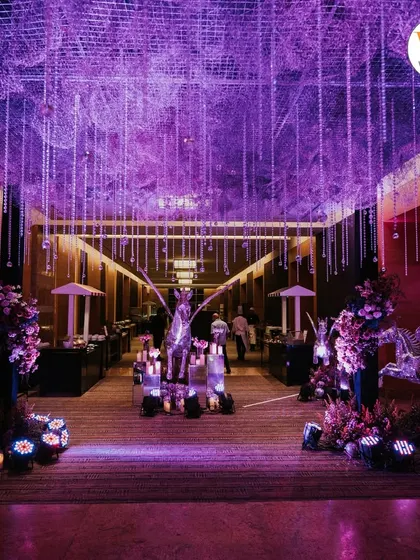 The grand entrance to the celestial Sangeet. The entire hallway was transformed with purple lighting, candles, and decor that built anticipation for the main event space.