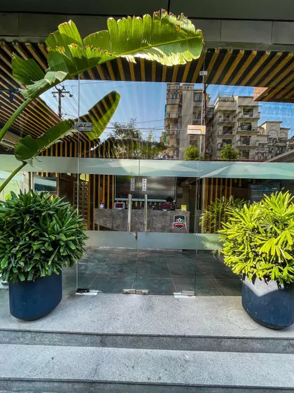The exterior of our facility, surrounded by greenery, provides a peaceful transition as you arrive for your practice.
