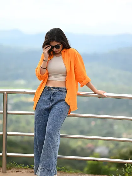 A full-length shot showing the relaxed, modern styling. The mountain view in the background adds a sense of adventure and freedom.
