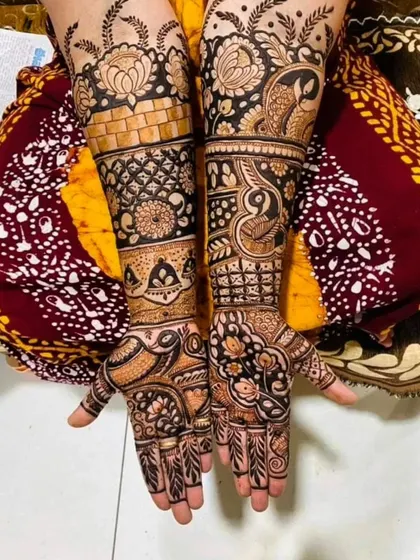 An intricate design that combines floral blocks, brick-like patterns, and delicate vines. The mix of different textures and motifs makes this full-arm mehendi visually captivating.