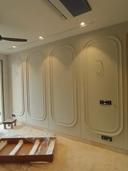 The process of bringing the vision to life, with the wall moldings being installed in the Harmony House family lounge.