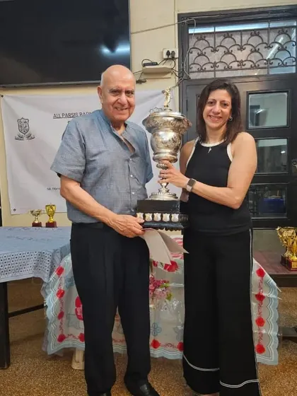 The legendary Naheed Divecha receiving one of her many trophies at the All Parsee Badminton Tournament, a testament to her enduring skill.