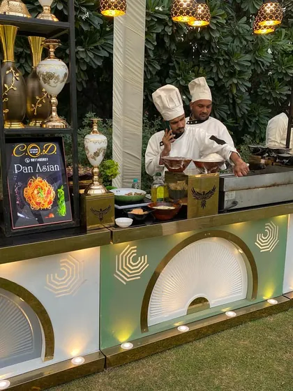 Our chefs in action at a live "Pan Asian" cooking station during an outdoor event. This setup allows guests to enjoy freshly prepared dishes made right in front of them, adding an interactive element to the meal.