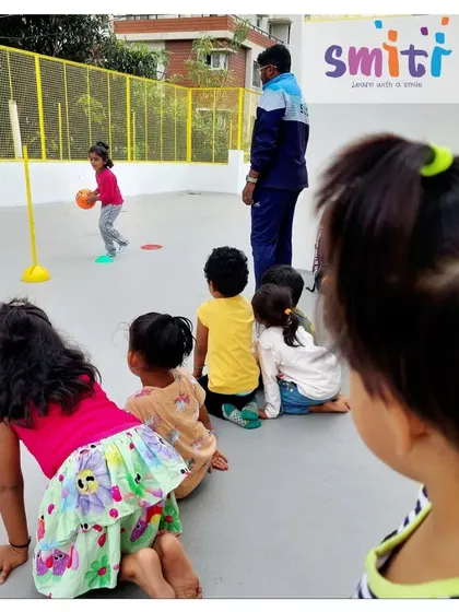 Children wait their turn to practice throwing a ball. This teaches them patience and the importance of taking turns.