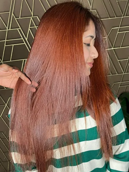 A side profile of this gorgeous red hair color, showing how it frames the face and adds a warm glow.