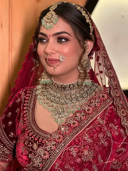 This side profile showcases the complete harmony of the bridal makeup and hair. The elegant updo and flawless makeup ensure she looks stunning from every angle.