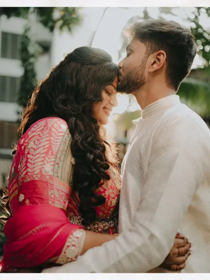A sweet moment captured during an engagement shoot. The bride's makeup is fresh and radiant, enhancing her happy glow.