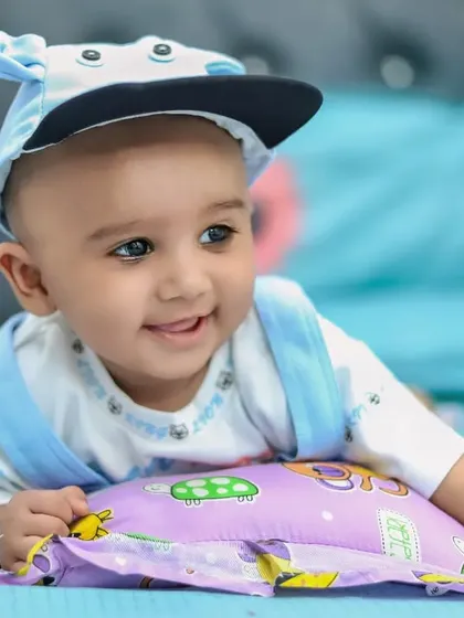 A happy baby boy enjoying his time during an at-home milestone session. We aim to make every photoshoot a fun experience for the little ones.
