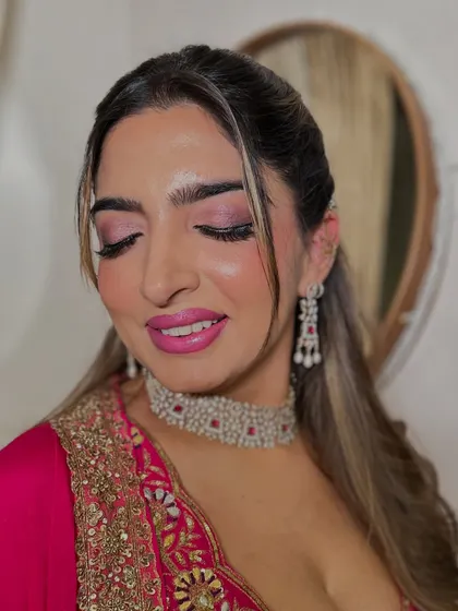 A detailed shot of the eye makeup. The soft pink tones are blended beautifully to create a look that is both romantic and glamorous.