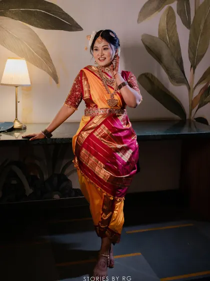A bold and beautiful bride in a traditional Madisar saree for her wedding ceremony, showcasing a look that is both fierce and elegant.