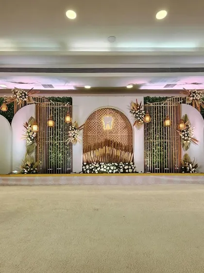 A full view of a beautiful boho-themed stage. The design incorporates natural textures, pampas grass, and intricate lattice work to create a look that is both earthy and elegant.