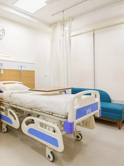 This patient room at Sarvodaya Hospital includes a comfortable sofa for family members and large windows to maximize natural light. The thoughtful layout ensures the space is functional for care and comfortable for recovery.
