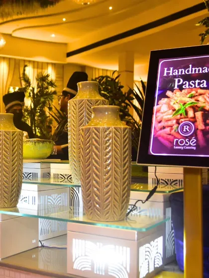 Our handmade pasta station, where guests can enjoy the authentic taste of Italy. The illuminated sign and elegant decor make this station a sophisticated addition to any event.