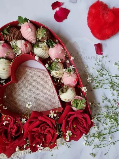 A heart-shaped box filled with chocolate-dipped strawberries and fresh roses. This was one of my most popular items for Valentine's Day.