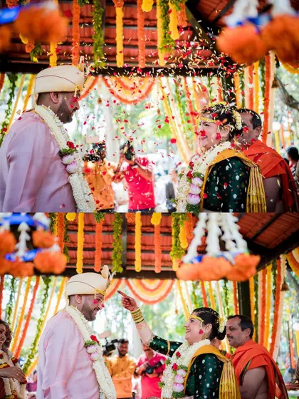A shower of flower petals rains down on the couple under a beautiful outdoor mandap. This shot captures the festive and colorful atmosphere of the wedding.