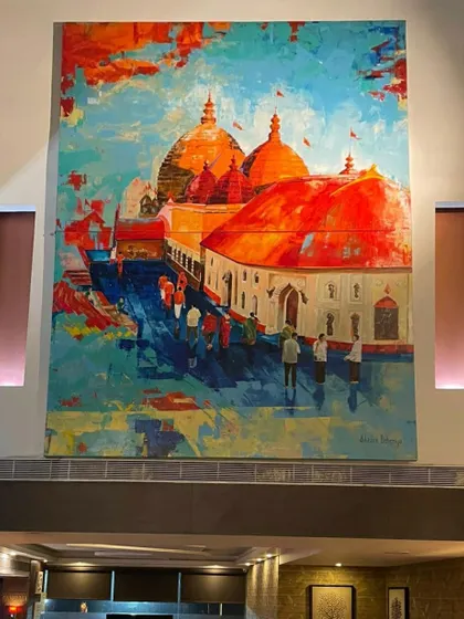 The massive 9x12 feet Kamakhya Temple painting installed at its final location. The scale and vibrant colors create an immersive experience of the sacred site.