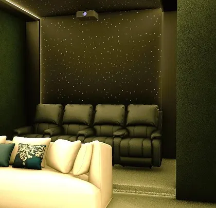 This angle highlights the tiered layout, with a sofa and bed in the front and dedicated recliners on a raised platform in the back.