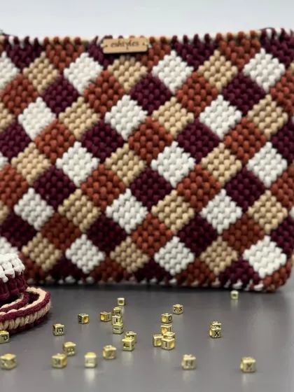 A close-up of the multi-tonal checkered pattern, with some letter beads spelling out a name. Customization is key!