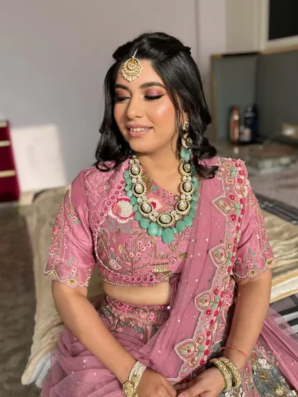 A close-up of Saumya's makeup. The pink eyeshadow is blended softly for a romantic feel, paired with a matching lip color.