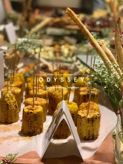 A close-up of our grilled corn on the cob, served with breadsticks. This is a simple yet popular item on our grazing tables, adding a rustic and savory touch.