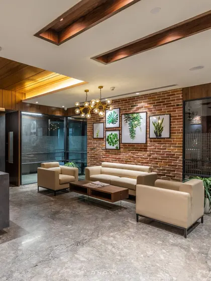 The waiting lounge at Savannah Seeds features an exposed brick wall, biophilic art, and comfortable seating. My general contracting services ensured the design's vision for a green and welcoming workspace was fully realized.