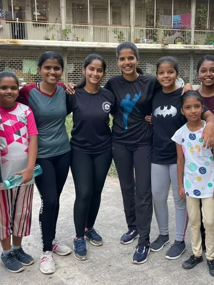 Some of the young girls from our November 2023 free training camp, smiling together after a session. Our goal is to create a safe and empowering space where girls can build confidence and friendship through martial arts.
