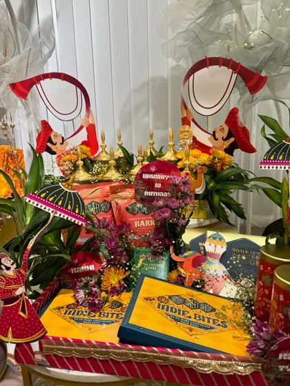 A vibrant and colorful Rakhi hamper display. We incorporated traditional Rajasthani puppets and bright florals to complement the festive packaging of the sweets and gifts.