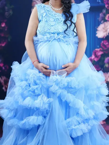 This sky blue cloud gown is perfect for a dreamy maternity photoshoot. The delicate lace top and tiered ruffles create a beautiful, ethereal look. I offer delivery all over India.